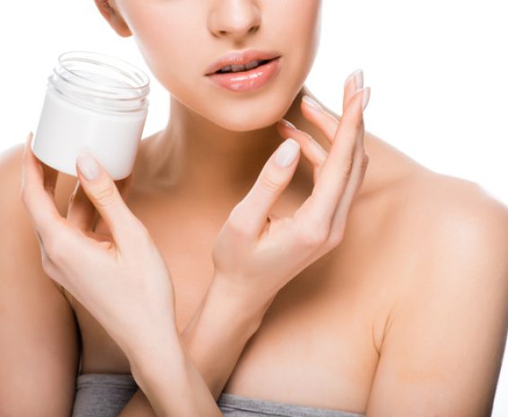 stock-photo-cropped-view-woman-holding-container-while-applying-cosmetic-cream-isolated